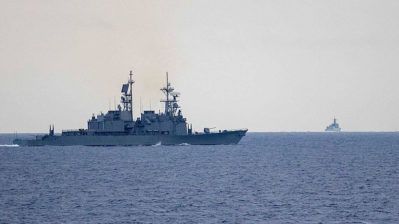Taiwan guided missile destroyer Ma Kong DDG1805, left, monitors Chinese guided missile destroyer Xi'an DDG15, right, near Taiwan.