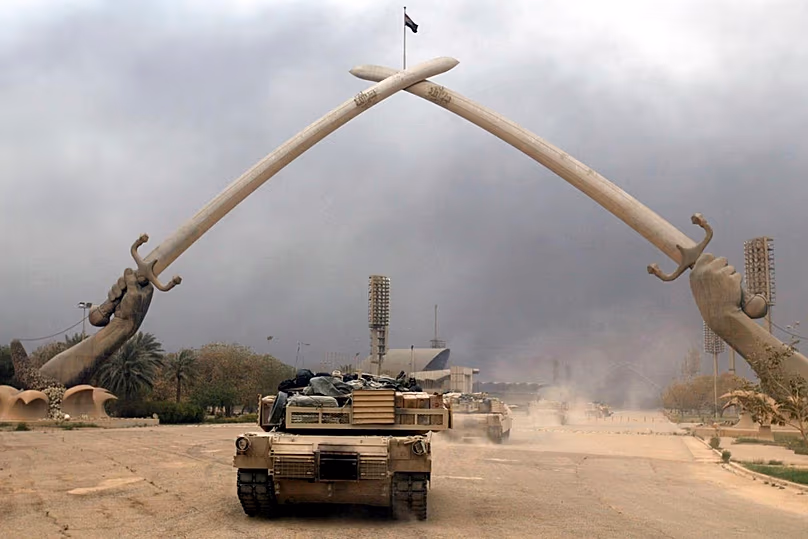 FILE: Charlie Company Task Force 1-64 of the 3rd Infantry Division rolls into a major park in downtown Baghdad, 7 April 2003